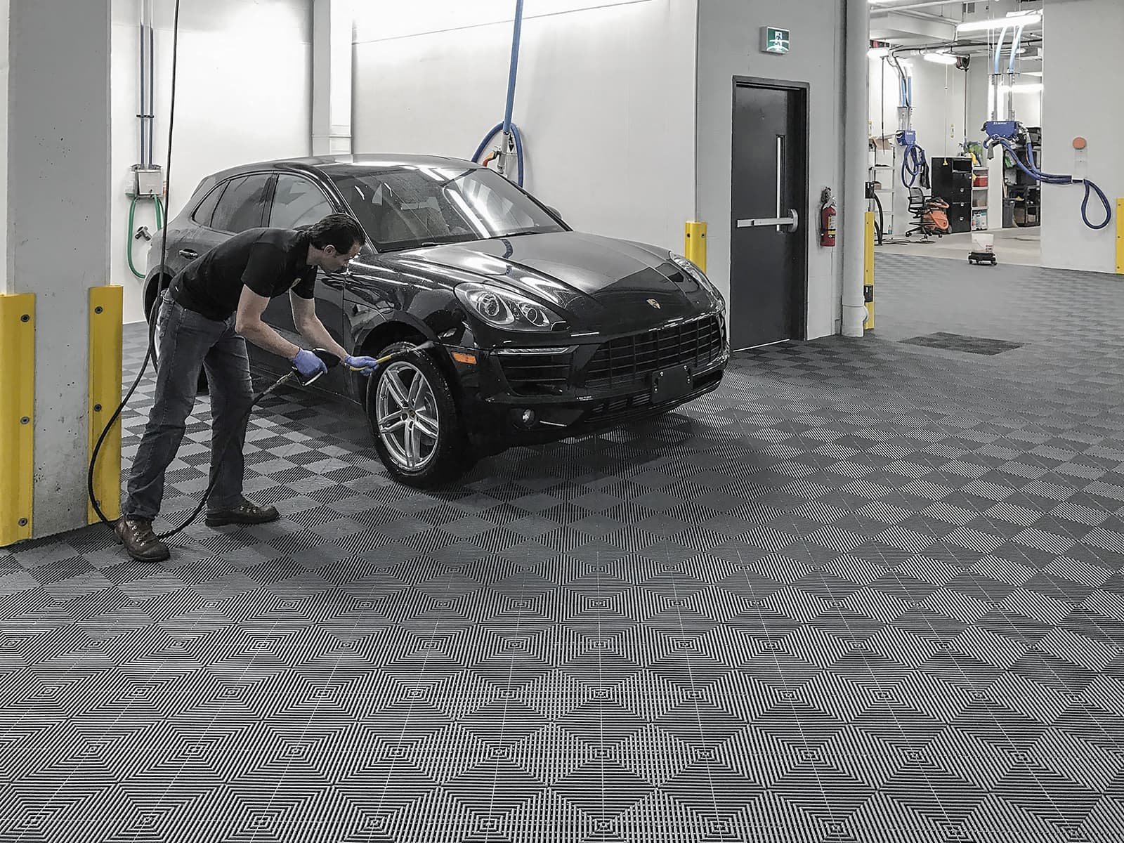 garage floor tiles and a man washing the car - Garage Living