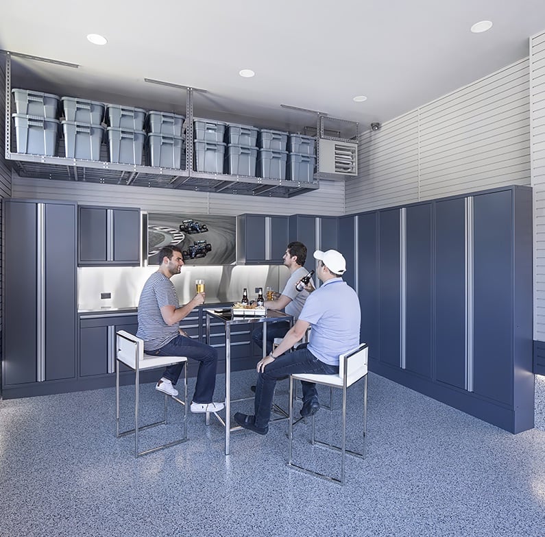 three men relaxing in garage three men relaxing in garage