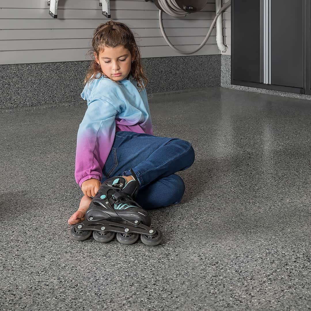 Girl rollerblades garage floor - Garage Living