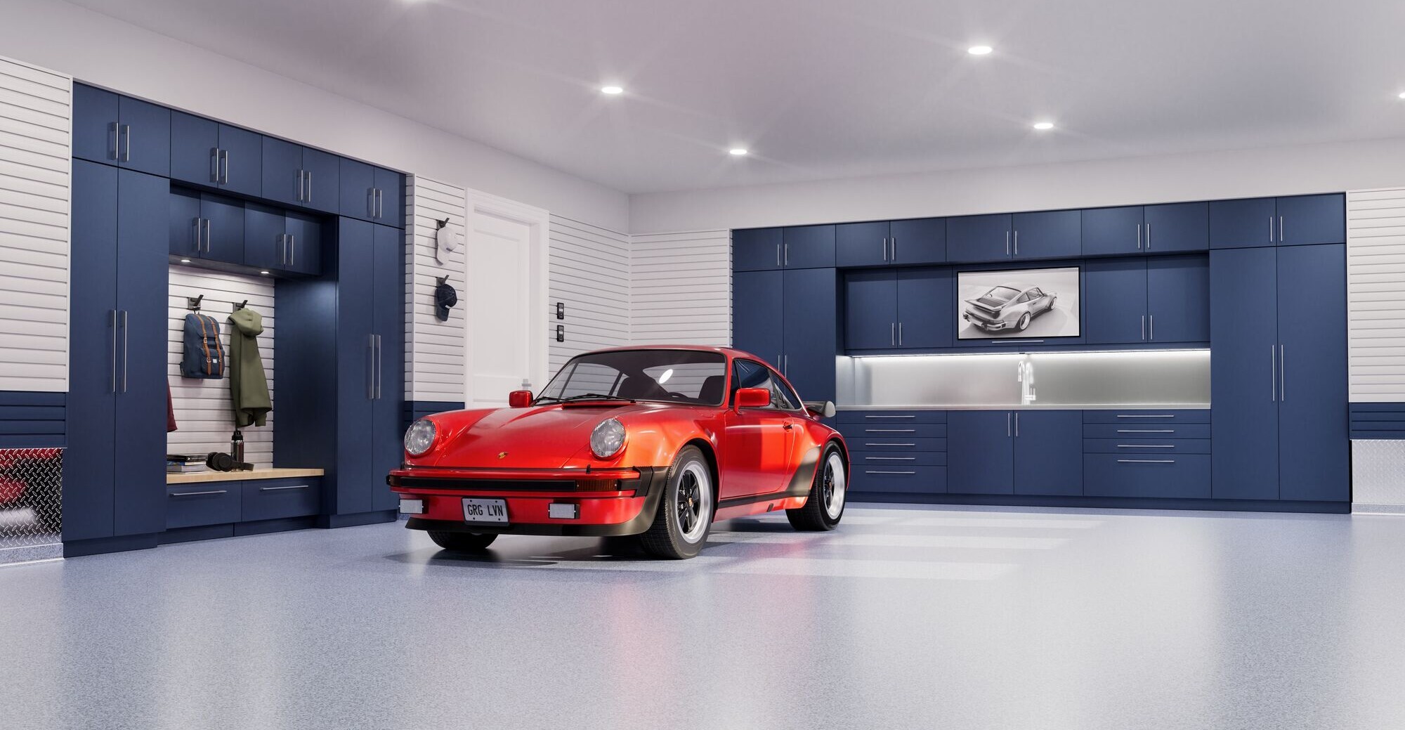 A freshly renovated garage shows the value of a clean and polished final product with our blue Tecnica cabinets and two-toned slatwall.