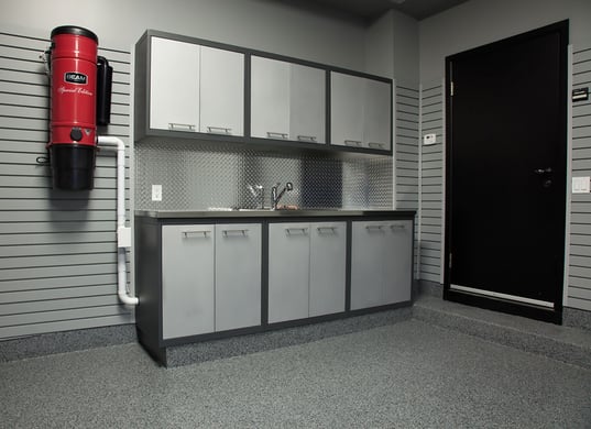 A&nbsp;Floortex® floor coating&nbsp;in Nightfall was applied to the floor, foundation walls, a wide step and a custom kick plate below the cabinets.&nbsp;GL Premium&nbsp;cabinetry in silver and granite provide storage.
