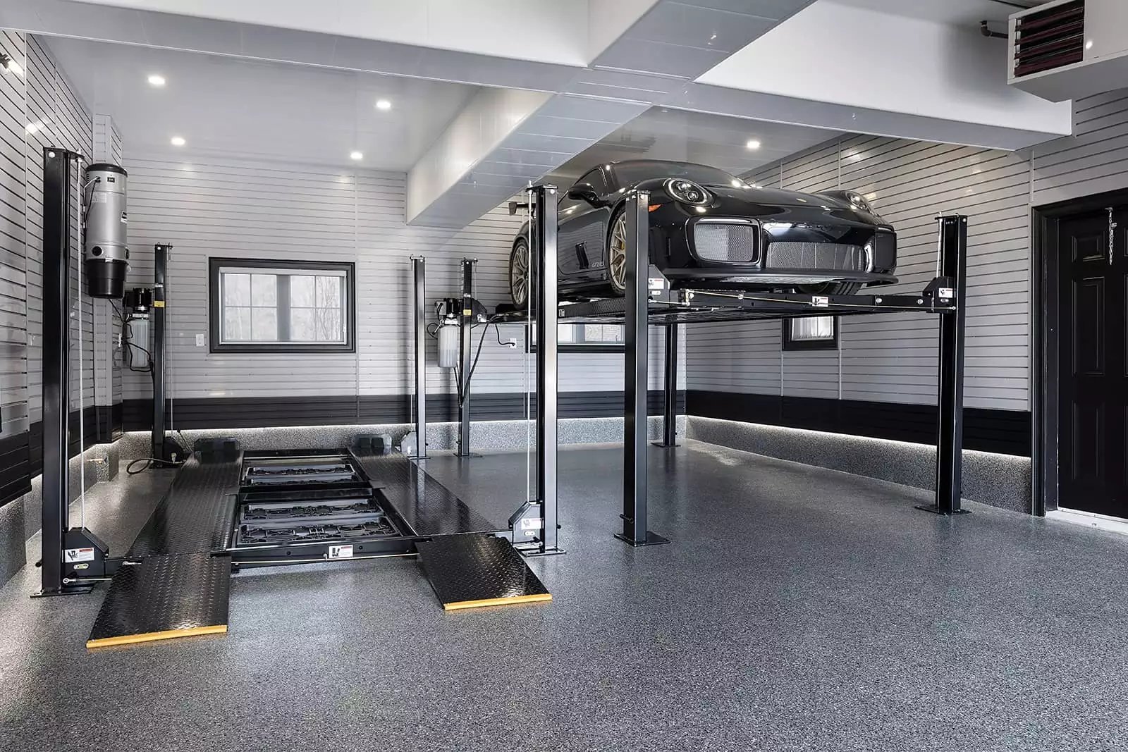 Car lift - Black Porsche elevated - Garage Living