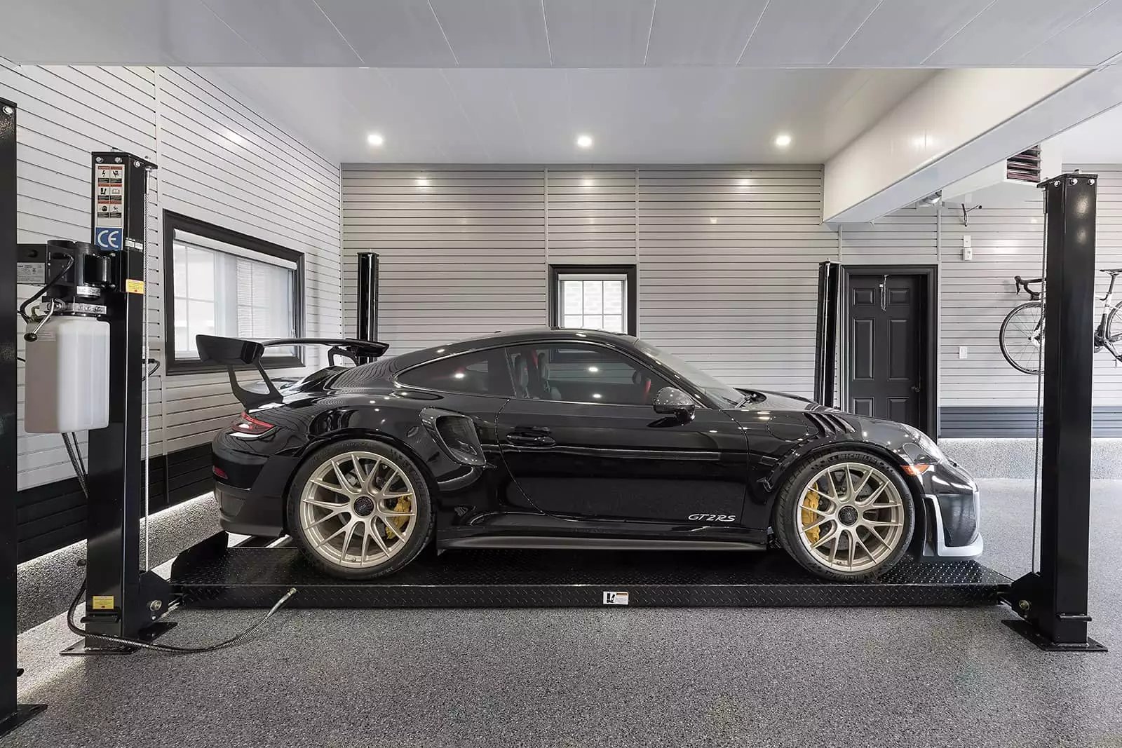 Car lift with black Porsche - Garage Living