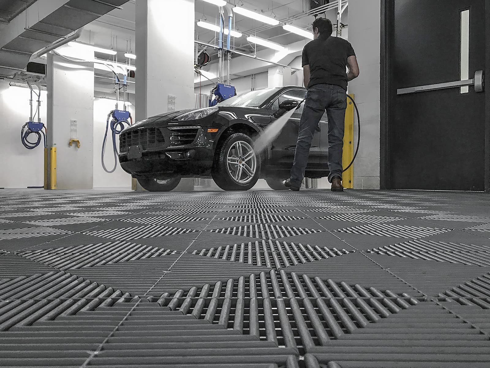 garage floor tiles and a man washing the car - Garage Living